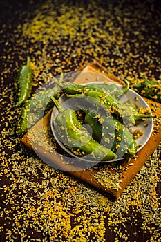 Green chilli pickle marinated in mustard seeds and mustard oil. Dark gothic style still life concept photo