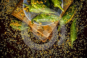 Green chilli pickle marinated in mustard seeds and mustard oil. Dark gothic style still life concept photo