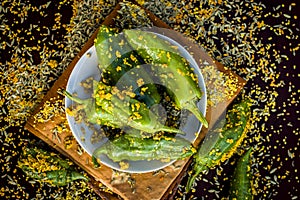 Green chilli pickle marinated in mustard seeds and mustard oil. Dark gothic style still life concept photo