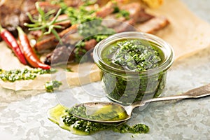 Green chimichurri sauce with grilled steak