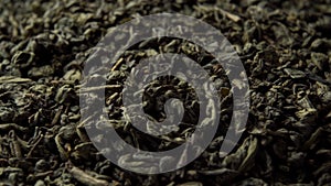 Green Chinese tea gunpowder. Dried coiled leaves close up. Rotation