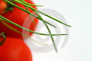 Green chives over tomatoes