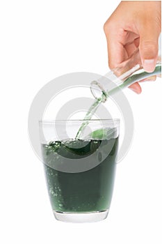 Green chlorophyll in glass and hands