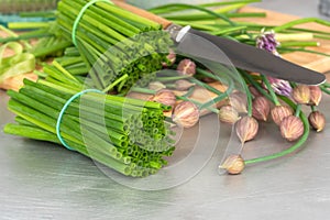 Green chopped chives and knife on kitchen table