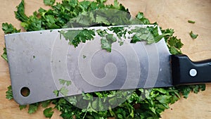 green chopped parsley, metal kitchen hatchet, vegetable cutting board, food