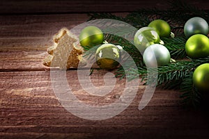 Green christmas balls in fir branches and a small Christmas tree