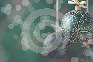 Green christmas balls hanging on abstract background