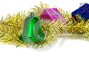 Green Christmas bells are in the tinsel and gift box