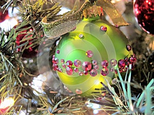 Green Christmas bulb with red crystals and velvet glitter ribbon, horizontal