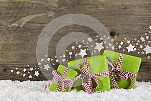 Green christmas presents on wooden background for a gift certificate.