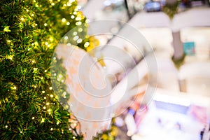 Green christmas tree with blurry department store