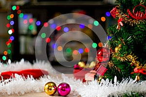 The green Christmas tree decorated with small bulbs is a beautiful bokeh. Christmas tree decoration with white, red, golden balls