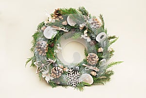 Green christmas wreath with decorations isolated on white background. Eco style with natural accesories: pinecones photo