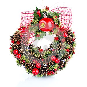 Green christmas wreath with decorations on white