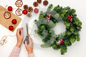 Green christmas wreath near matherials and instruments