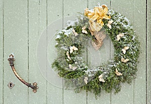 Green Christmas wreath in snowfall