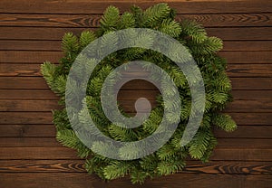 Green Christmas wreath on a wooden background. Christmas decor