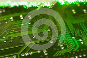 Green circuit board close up shot, defocused optical fibre.