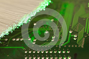 Green circuit board close up shot, optical fibre.