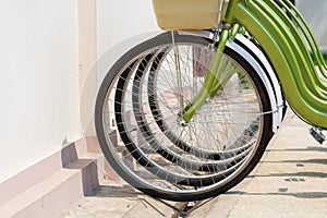 Green city bicycles parked next to the rental shop in Luang Prabang, Laos