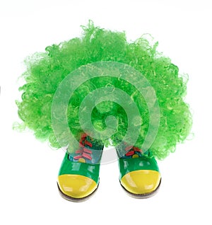 green clown hat and boots isolated on white