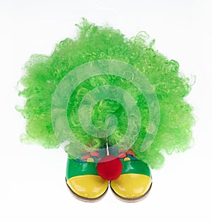 green clown hat and boots isolated on white