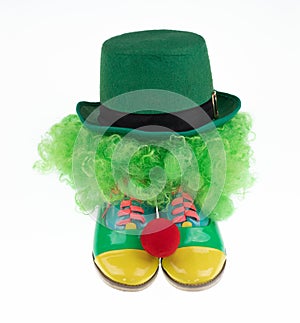 green clown hat and boots isolated on white