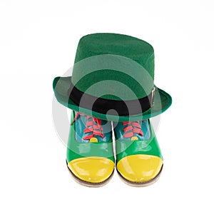 green clown hat and boots isolated on white