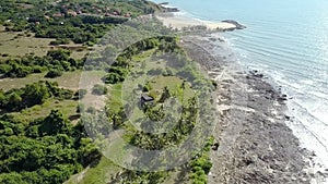 Green Coast and Grey Dirty Beach Washed by Ocean Upper View