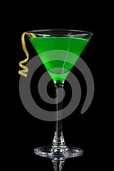 Green cocktail with absinth in martini glass for halloween night