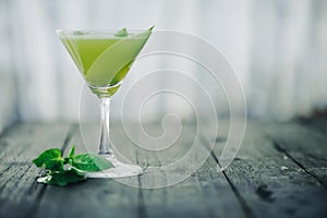 Green cocktail. Selective focus. Blurred foreground and background