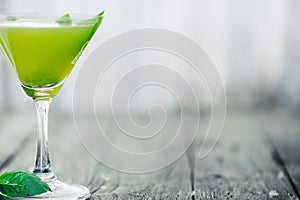 Green cocktail. Selective focus. Blurred foreground and background
