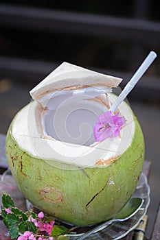 Green coconuts water with drinking straw
