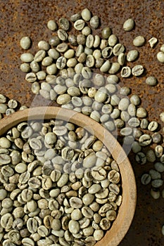 Green coffee beans in wooden bowl