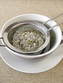 Green coffee in tea strainer