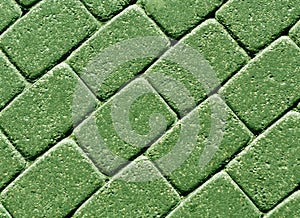 Green color cobblestone pavement surface.