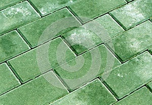 Green color cobblestone pavement texture.