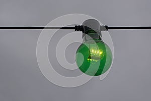 Green color lightbulb on string