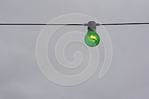 Green color lightbulb on string