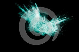 Green color powder explosion cloud isolated on black background.