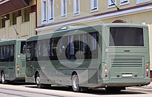 Green colored military buses on the street