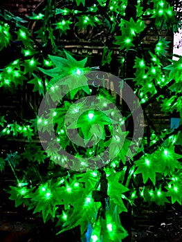 green colour led light decorated in a tree