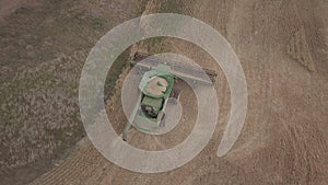 green combine harvesting barley in north dakota