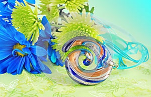 Green composition with glass pendant.