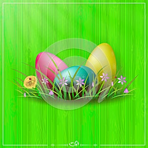 Green composition with a wood pattern, Easter eggs of different colors with a pattern, grass and flowers