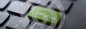 Green contact us button on computer keyboard