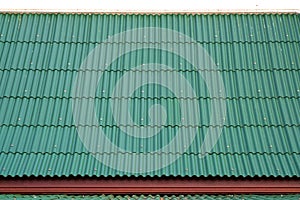 Green corrugated metal roof. background