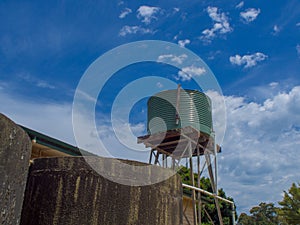 Green Corrugated water tank with blue sky