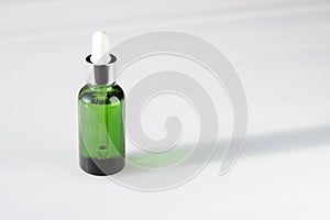 Green cosmetic bottle on a white background