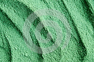 Green cosmetic clay powder kelp facial mask, spirulina body wrap texture close up, selective focus. Abstract background